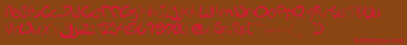 フォントNieknique – 赤い文字が茶色の背景にあります。