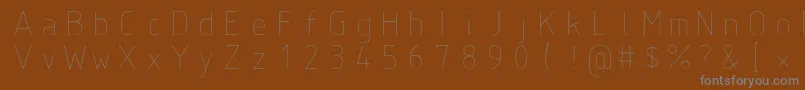 Isoct-fontti – harmaat kirjasimet ruskealla taustalla