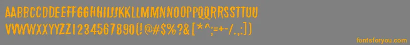 フォントMarchOfThePigs – オレンジの文字は灰色の背景にあります。