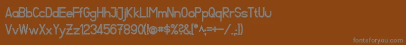 フォントFibelSuedBold – 茶色の背景に灰色の文字