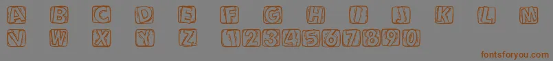 Woodcuttedcaps Font – Brown Fonts on Gray Background