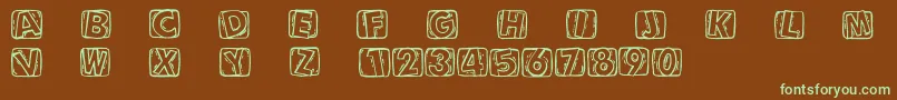 フォントWoodcuttedcaps – 緑色の文字が茶色の背景にあります。