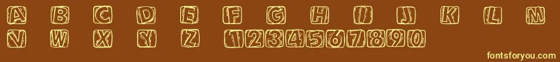 Woodcuttedcaps-fontti – keltaiset fontit ruskealla taustalla