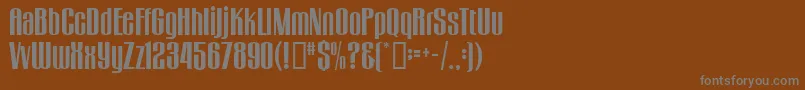 GogoBig-fontti – harmaat kirjasimet ruskealla taustalla