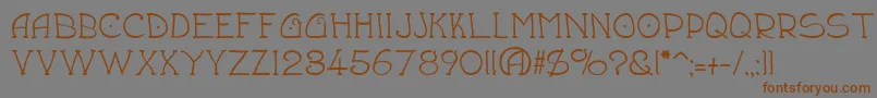 フォントDraughtsman – 茶色の文字が灰色の背景にあります。