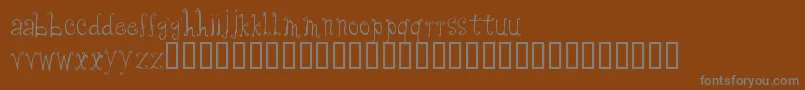 フォントCfanabelle – 茶色の背景に灰色の文字