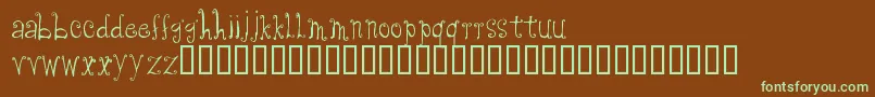フォントCfanabelle – 緑色の文字が茶色の背景にあります。