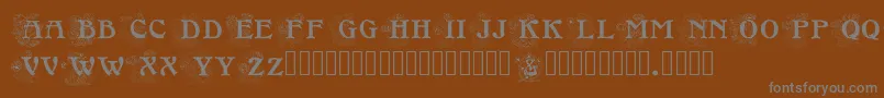 Floralcapsnouveau-fontti – harmaat kirjasimet ruskealla taustalla