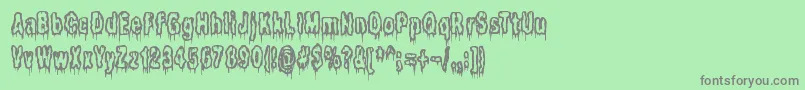 フォントItLivesInTheSwampBrk – 緑の背景に灰色の文字