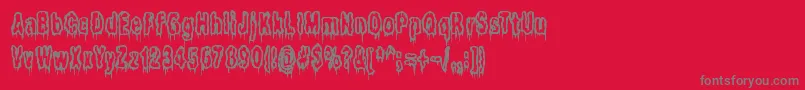 フォントItLivesInTheSwampBrk – 赤い背景に灰色の文字