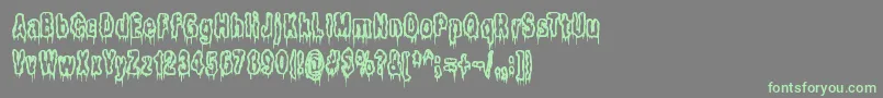 フォントItLivesInTheSwampBrk – 灰色の背景に緑のフォント