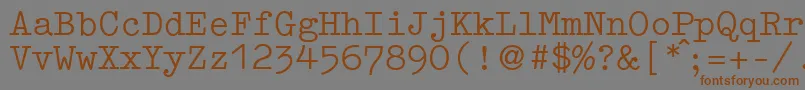 フォントGermantypewriterRegular – 茶色の文字が灰色の背景にあります。