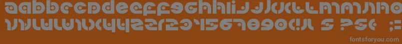 Kovacssp-fontti – harmaat kirjasimet ruskealla taustalla