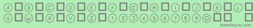 101DecoType1-fontti – harmaat kirjasimet vihreällä taustalla