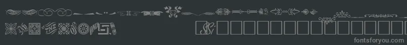 Шрифт WoodcutornamentstwosskRegular – серые шрифты на чёрном фоне