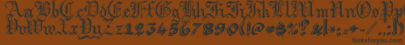 フォントArgorGotScaqh – 黒い文字が茶色の背景にあります