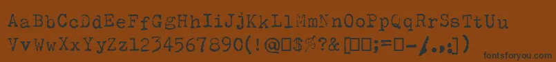 フォントOlivettiType2 – 黒い文字が茶色の背景にあります