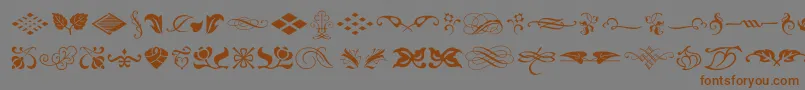 Czcionka TypeEmbellishmentsOneLetPlain.1.0 – brązowe czcionki na szarym tle