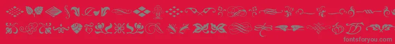 fuente TypeEmbellishmentsOneLetPlain.1.0 – Fuentes Grises Sobre Fondo Rojo