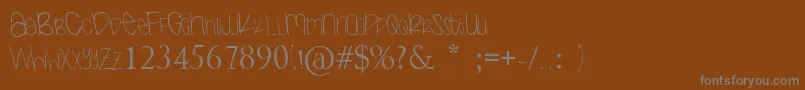 Nextok-fontti – harmaat kirjasimet ruskealla taustalla