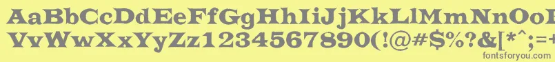 フォントATrianglerrgh – 黄色の背景に灰色の文字