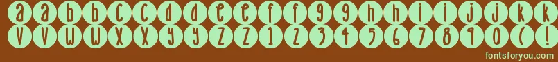 フォントDjbLemonHeadDots – 緑色の文字が茶色の背景にあります。