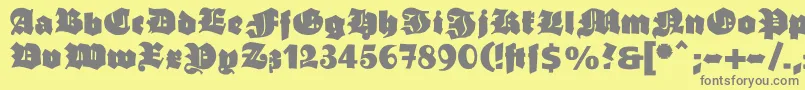 Ganzgrobegotisch-Schriftart – Graue Schriften auf gelbem Hintergrund