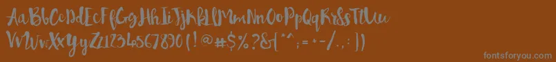 フォントPennellino – 茶色の背景に灰色の文字