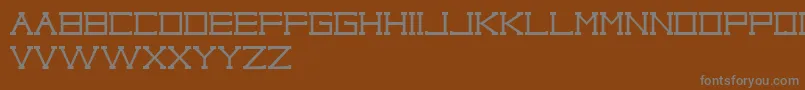 Шрифт TypoCapitalRegularSoloLetrasParaDafont – серые шрифты на коричневом фоне