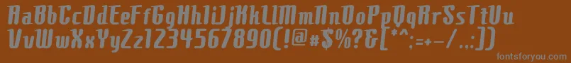 ComonsBold-fontti – harmaat kirjasimet ruskealla taustalla