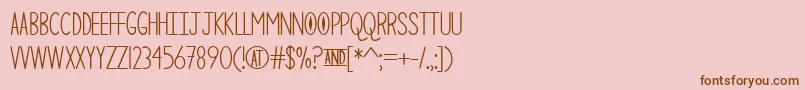 フォントTheCuriousCat – ピンクの背景に茶色のフォント