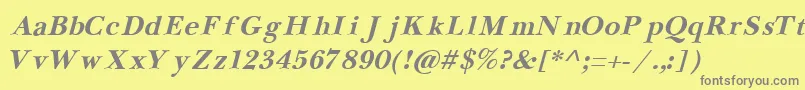 フォントNewbaskervilleCyrillicBoldItalic – 黄色の背景に灰色の文字