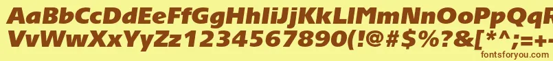 フォントTornadoultrablackcItalic – 茶色の文字が黄色の背景にあります。