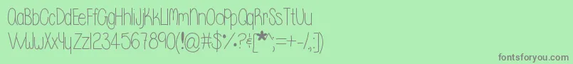 フォントWhisperadream – 緑の背景に灰色の文字