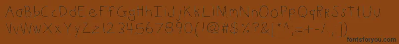 Kbkinderwrite Font – Black Fonts on Brown Background