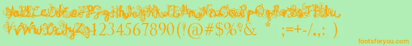 DenneAngel-Schriftart – Orangefarbene Schriften auf grünem Hintergrund