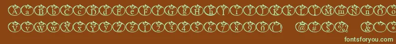 フォントTomate – 緑色の文字が茶色の背景にあります。