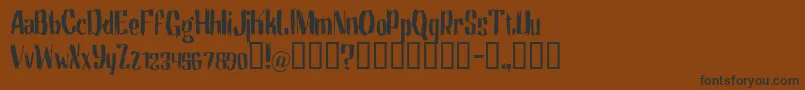 フォントMotrg – 黒い文字が茶色の背景にあります