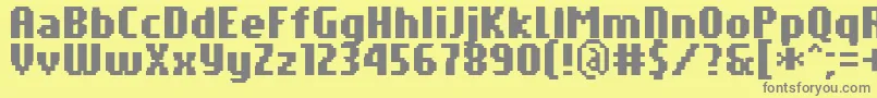 PfTempestaSevenCompressedBold-fontti – harmaat kirjasimet keltaisella taustalla