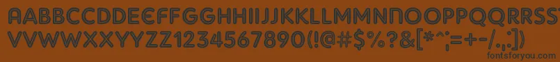 フォントAdamGorryInline – 黒い文字が茶色の背景にあります