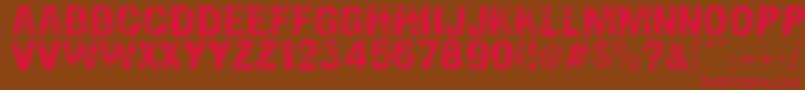 フォントOverprintDsg – 赤い文字が茶色の背景にあります。