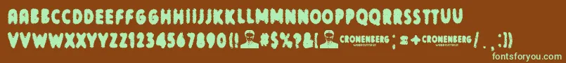 フォントCronenberg – 緑色の文字が茶色の背景にあります。