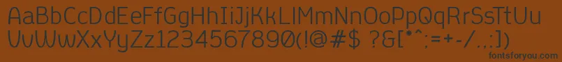 AleksandracRegular Font – Black Fonts on Brown Background
