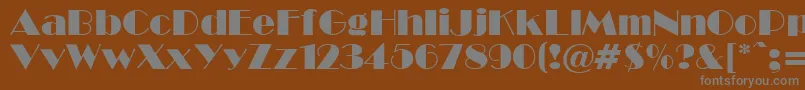 Broadcyr-fontti – harmaat kirjasimet ruskealla taustalla