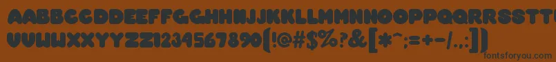 OvermuchRegular Font – Black Fonts on Brown Background