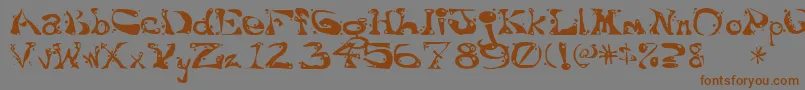 Aajaxsurrealfreak-Schriftart – Braune Schriften auf grauem Hintergrund
