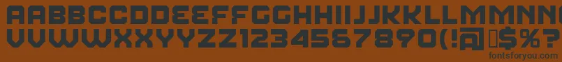 フォントFearFactor – 黒い文字が茶色の背景にあります
