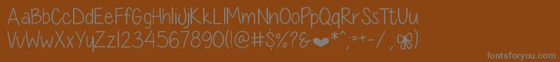 DiamondGirlSkinny Font – Gray Fonts on Brown Background