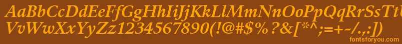 フォントGuardiltstdBolditalic – オレンジ色の文字が茶色の背景にあります。