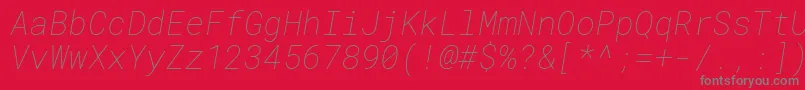 RobotomonoThinitalic-fontti – harmaat kirjasimet punaisella taustalla
